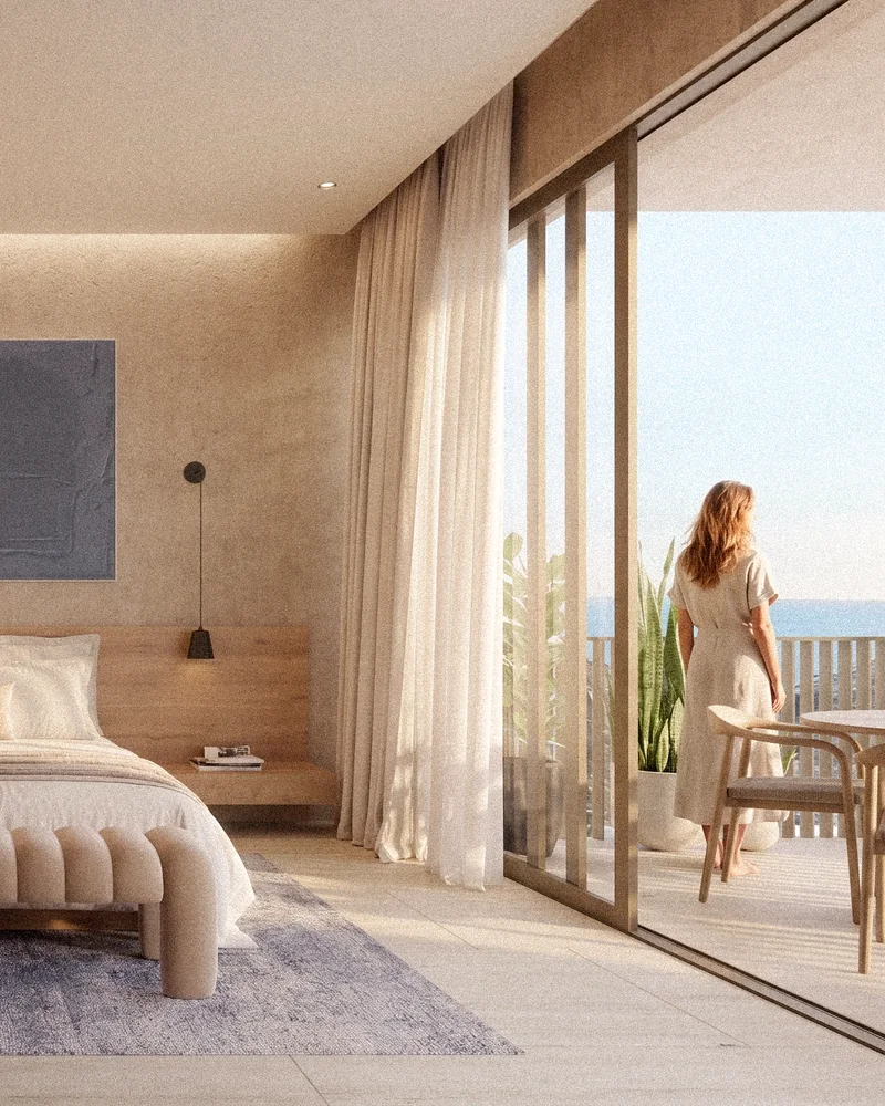 Rec&aacute;mara de una Residence abierta a un balc&oacute;n con vista al mar